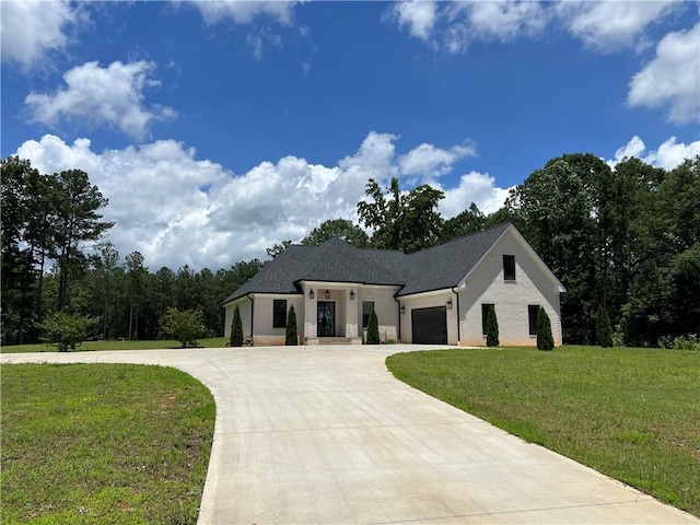 613 Bill Rutledge Rd, Winder, GA 30680 - view of front of house featuring curved driveway, a front lawn, and an attached garage