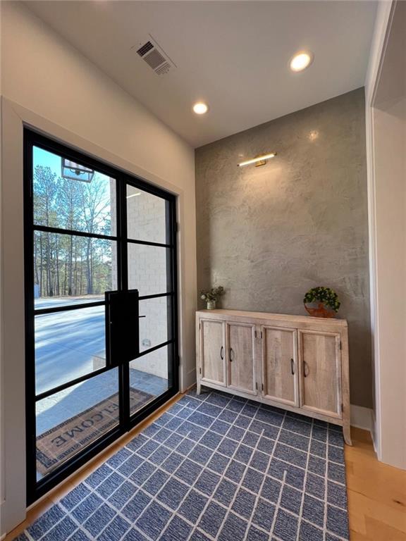 interior space featuring baseboards, visible vents, and recessed lighting