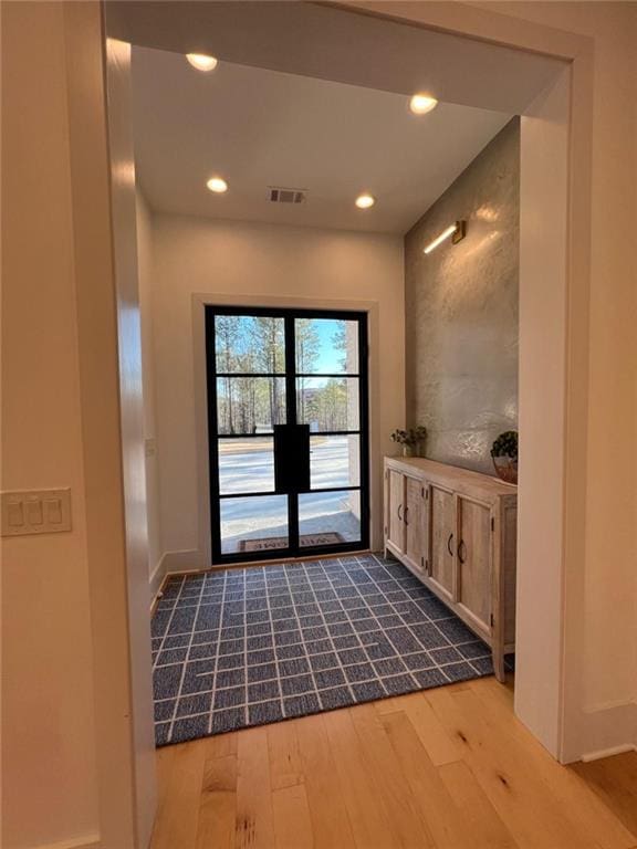 doorway to outside with french doors, recessed lighting, visible vents, wood finished floors, and baseboards