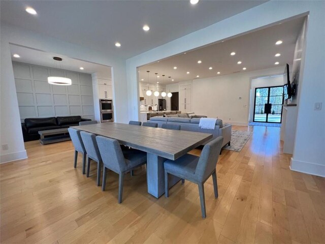 dining room featuring light wood-style floors, recessed lighting, and baseboards