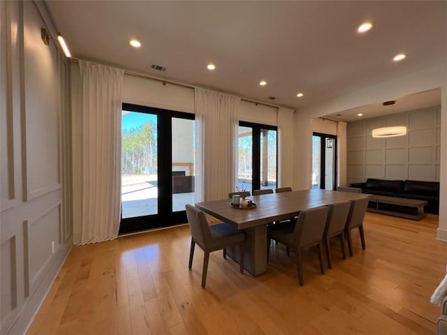 dining space with light wood-style floors, recessed lighting, visible vents, and plenty of natural light
