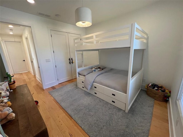 bedroom featuring wood finished floors, visible vents, and recessed lighting