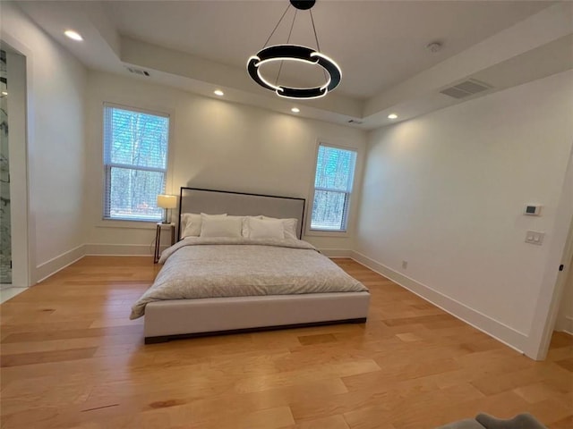 bedroom with light wood-style floors, baseboards, visible vents, and recessed lighting