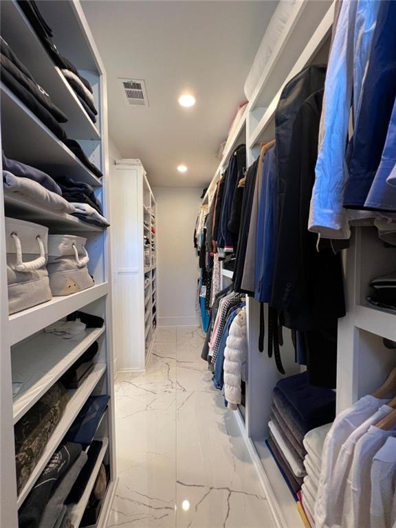 spacious closet featuring marble finish floor and visible vents
