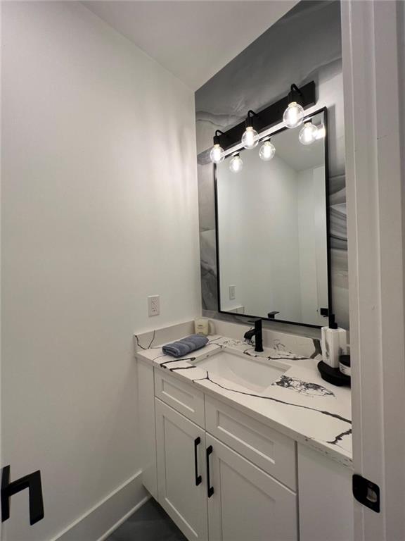 bathroom featuring vanity and baseboards