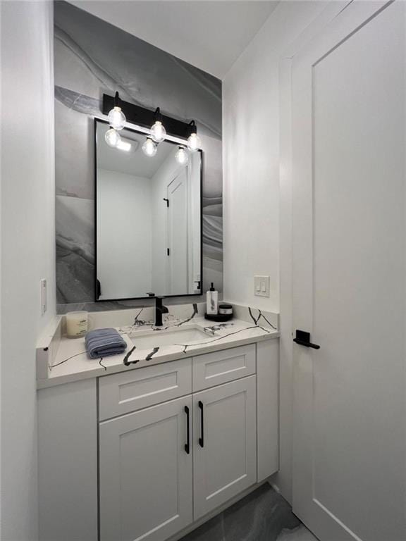 bathroom featuring marble finish floor and vanity