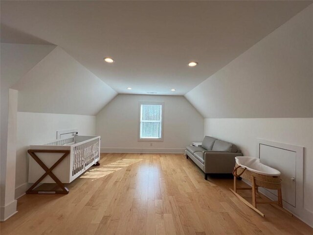 bonus room with lofted ceiling, baseboards, light wood finished floors, and recessed lighting
