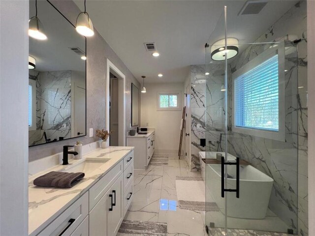 613 Bill Rutledge Rd, Winder, GA 30680 - bathroom with marble tiled flooring, two vanities, a marble finish shower, a soaking tub, and recessed lighting