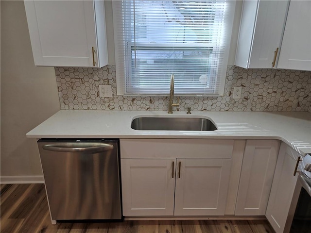 kitchen with white cabinetry, appliances with stainless steel finishes, light countertops, and a sink