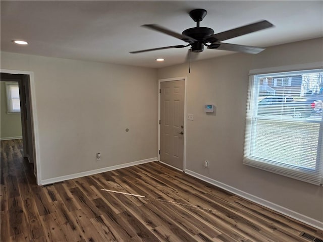 spare room featuring baseboards, visible vents, a ceiling fan, dark wood-style floors, and recessed lighting