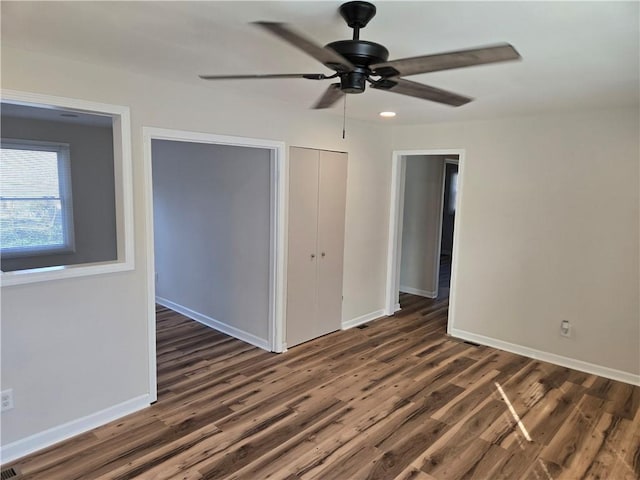 unfurnished room featuring ceiling fan, baseboards, and wood finished floors