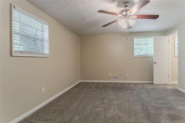 spare room with carpet flooring, a ceiling fan, baseboards, and a textured ceiling