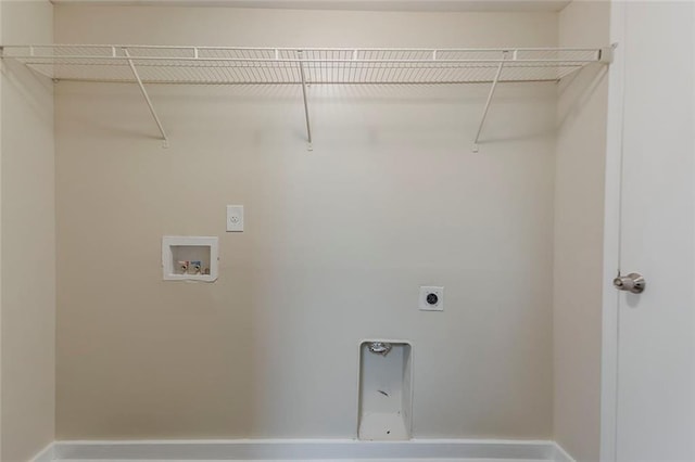 washroom featuring electric dryer hookup, washer hookup, and baseboards