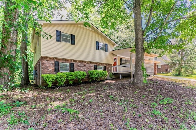 split level home with brick siding and an attached carport