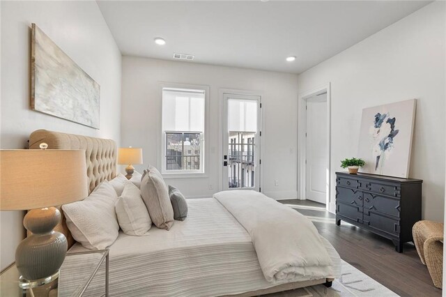 bedroom with access to exterior and dark hardwood / wood-style flooring