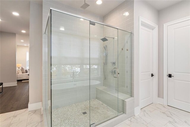 bathroom with hardwood / wood-style flooring and walk in shower