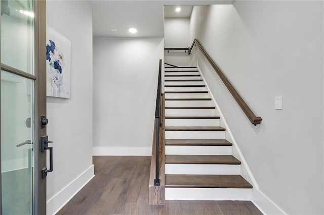 stairs with hardwood / wood-style flooring