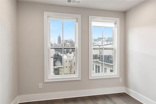 spare room with dark hardwood / wood-style flooring