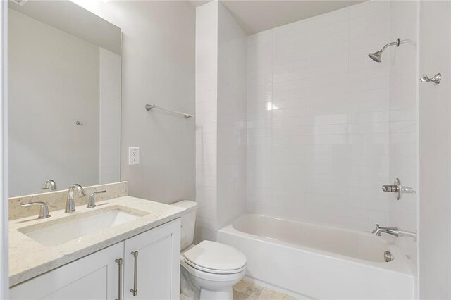 full bathroom featuring vanity, toilet, and tiled shower / bath