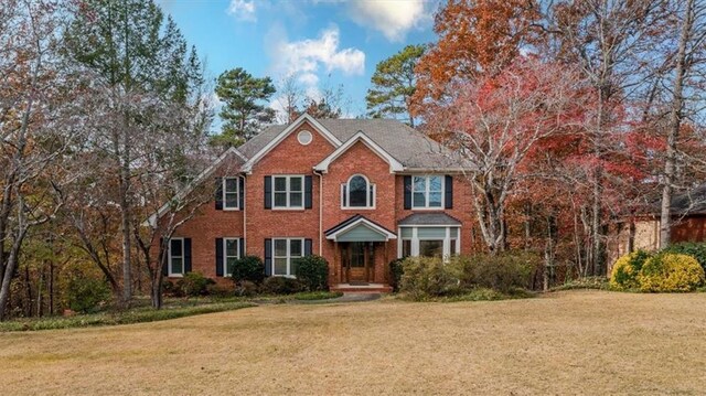 colonial inspired home with a front yard