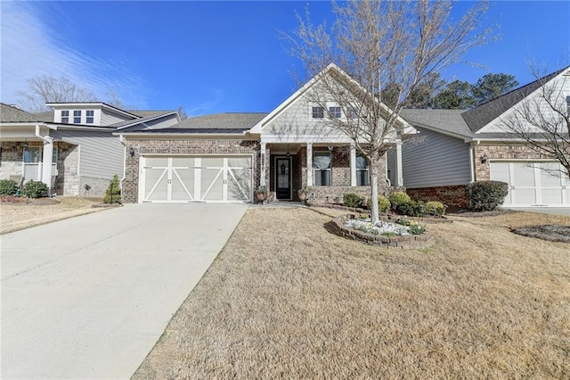 view of front of property featuring driveway, brick siding, and an attached garage