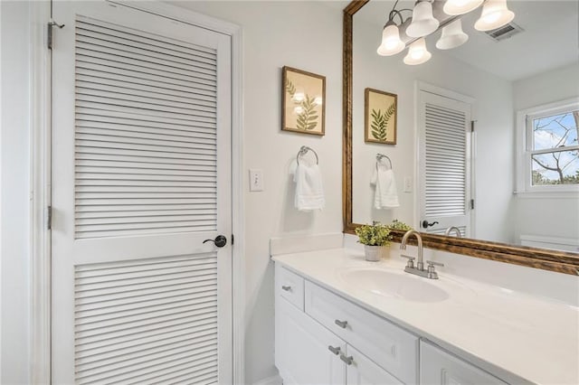 bathroom with vanity and an inviting chandelier