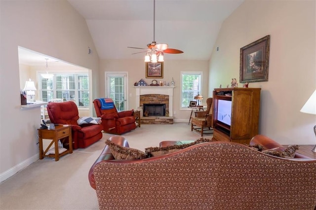 living room featuring a ceiling fan, baseboards, a fireplace, lofted ceiling, and carpet flooring