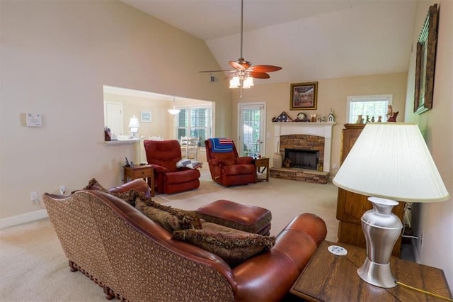 living area featuring plenty of natural light, lofted ceiling, a ceiling fan, and carpet