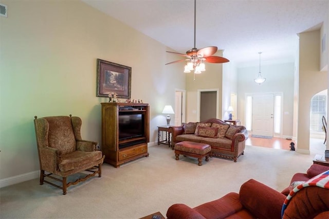 living area with light colored carpet, ceiling fan, baseboards, and visible vents