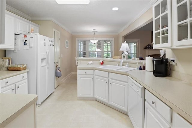 kitchen featuring light countertops, white appliances, white cabinets, and a sink
