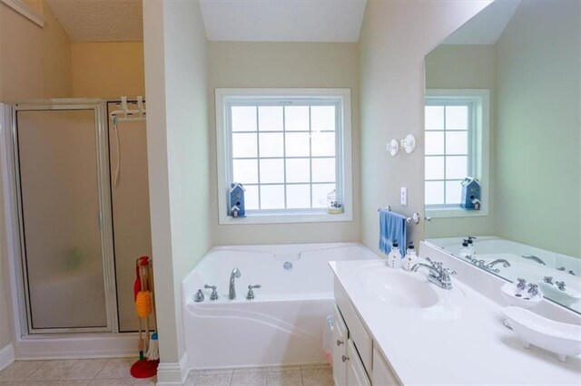 bathroom featuring baseboards, a garden tub, vanity, and a shower stall