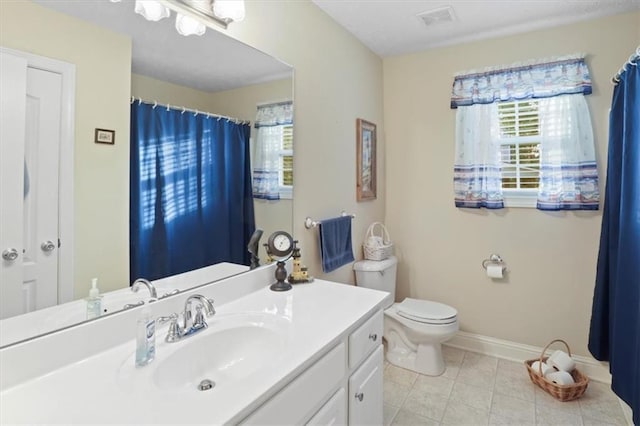 bathroom featuring tile patterned floors, toilet, visible vents, baseboards, and vanity