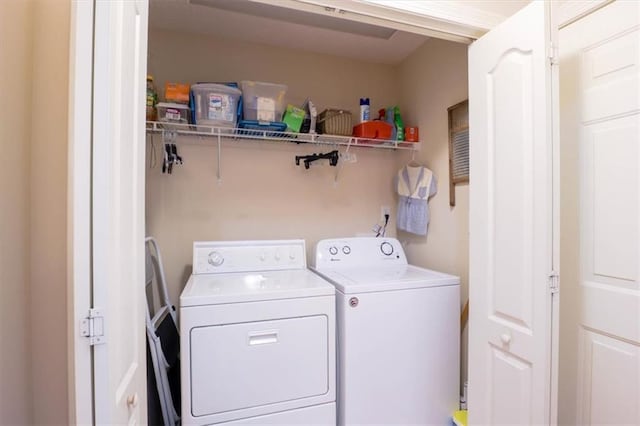 washroom featuring washing machine and clothes dryer and laundry area