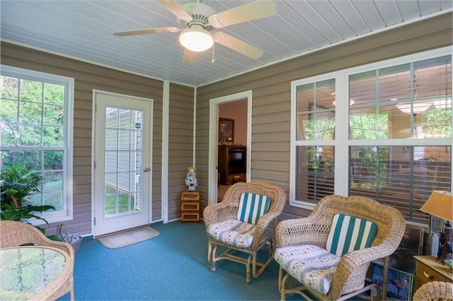 sunroom / solarium with a wealth of natural light and a ceiling fan