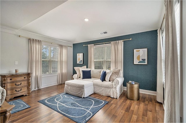 living area with ornamental molding and dark hardwood / wood-style floors