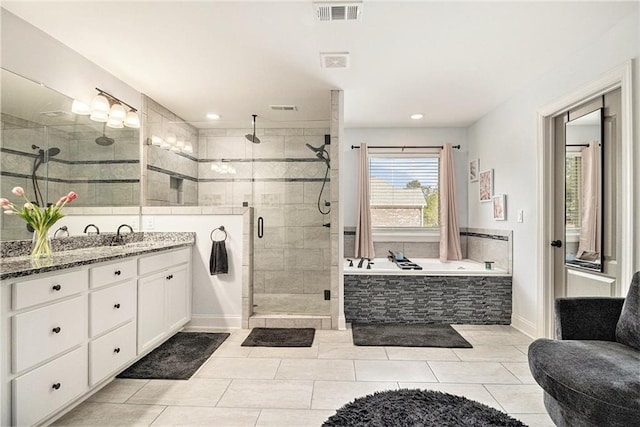 bathroom featuring tile patterned floors, vanity, and shower with separate bathtub