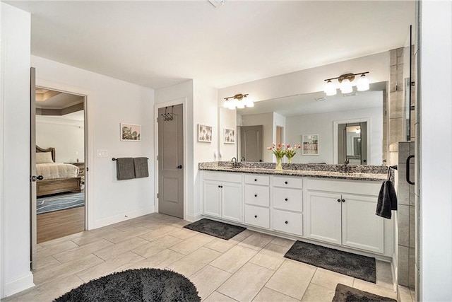 bathroom with vanity and a shower with door