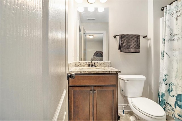 bathroom featuring vanity and toilet