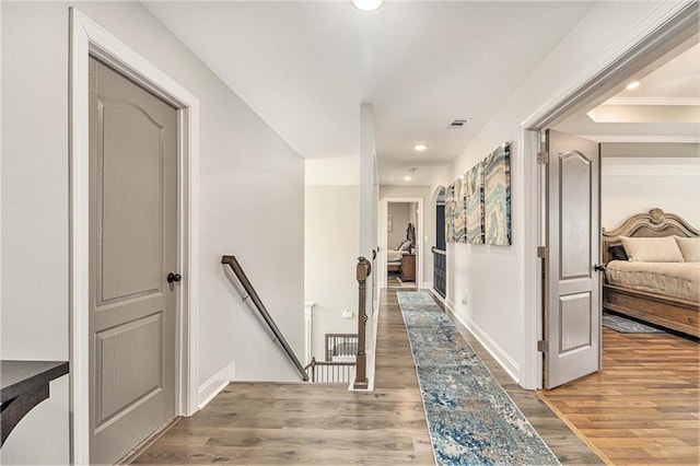 corridor with hardwood / wood-style floors