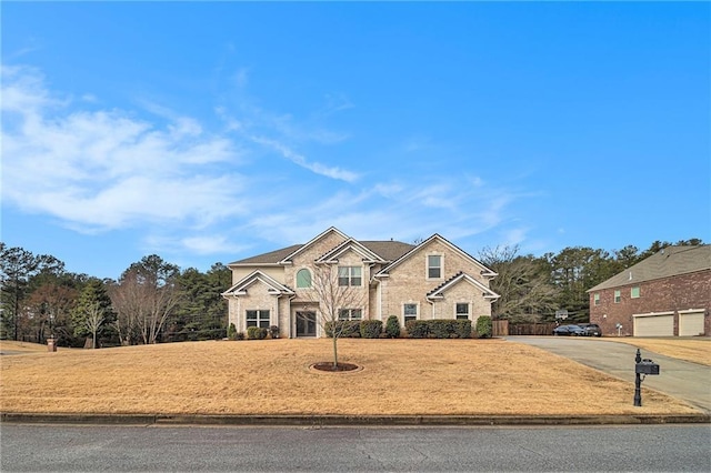 view of property with a garage and a front lawn