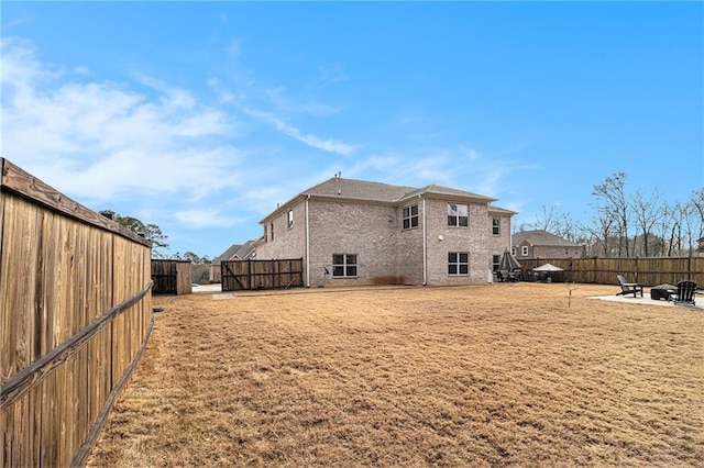 back of house with a patio area and a lawn