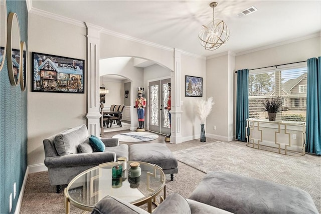 carpeted living room featuring an inviting chandelier, ornamental molding, french doors, and a healthy amount of sunlight