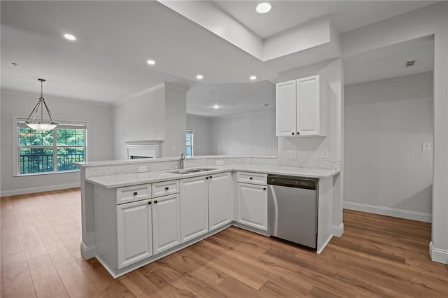 kitchen with sink, white cabinetry, stainless steel dishwasher, and light hardwood / wood-style flooring