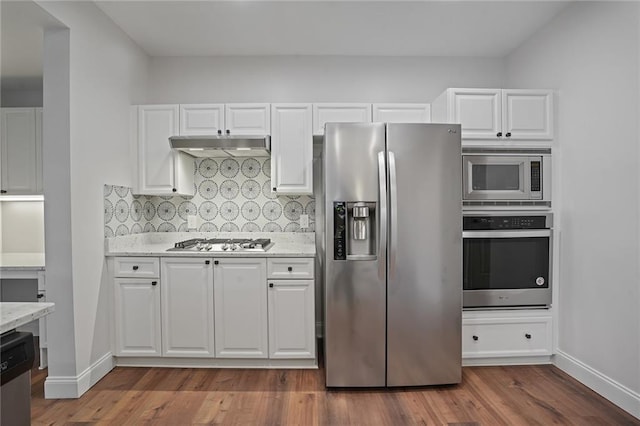 kitchen with dark wood-type flooring, white cabinets, and stainless steel appliances