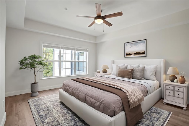 bedroom with ceiling fan and wood-type flooring