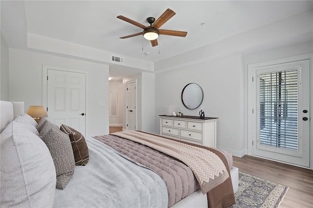 bedroom featuring light wood-type flooring, access to outside, and ceiling fan