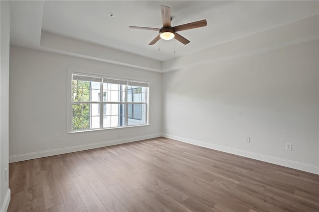 spare room with ceiling fan and light hardwood / wood-style floors