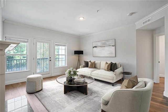 living room featuring hardwood / wood-style flooring and ornamental molding