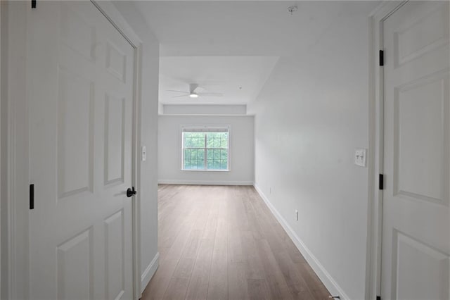 hallway with light hardwood / wood-style flooring