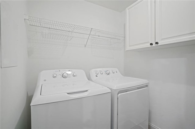 laundry room with cabinets and washing machine and dryer